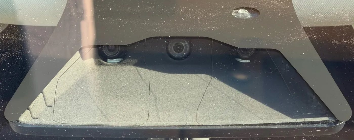 HW3 front windshield camera cluster — three identical dark lenses